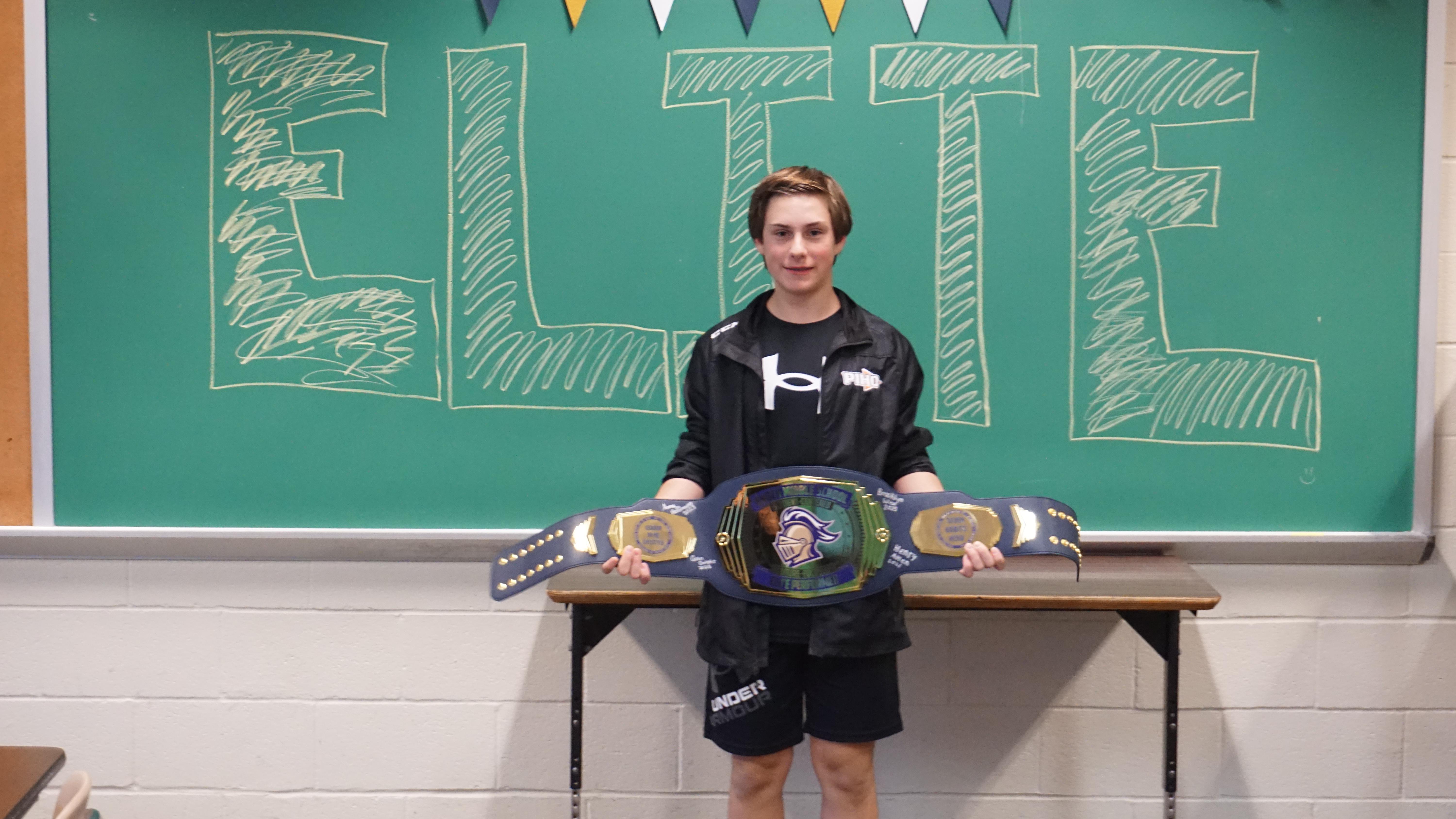 pic of a boy with a huge prize belt